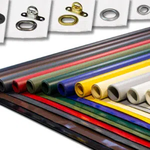 Ausgestellt sind gerollte Platten aus verschiedenfarbigen Materialien, wie LKW-Planen in Rot, Blau, Grün, Gelb und Grau. Darüber sind kleine Ösen aus Metall und Kunststoff in verschiedenen Designs auf weißem Untergrund angebracht.