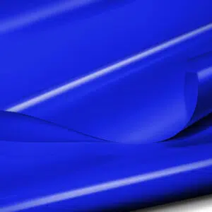 Nahaufnahme einer leuchtend blauen (900 g/m²) LKW-Folie, PVC-Folie – 3 m breit – Blau RAL5002. Licht wird von der glatten, hochwertig beschichteten Oberfläche mit subtilen Glanzlichtern und Schatten reflektiert und betont die weiche und fließende Textur.