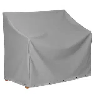 Die Abbildung zeigt eine rechteckige, graue Abdeckhaube für Gartenmöbel vor einem weißen Hintergrund. Die Abdeckhaube ist im unteren Bereich mit Ösen versehen.