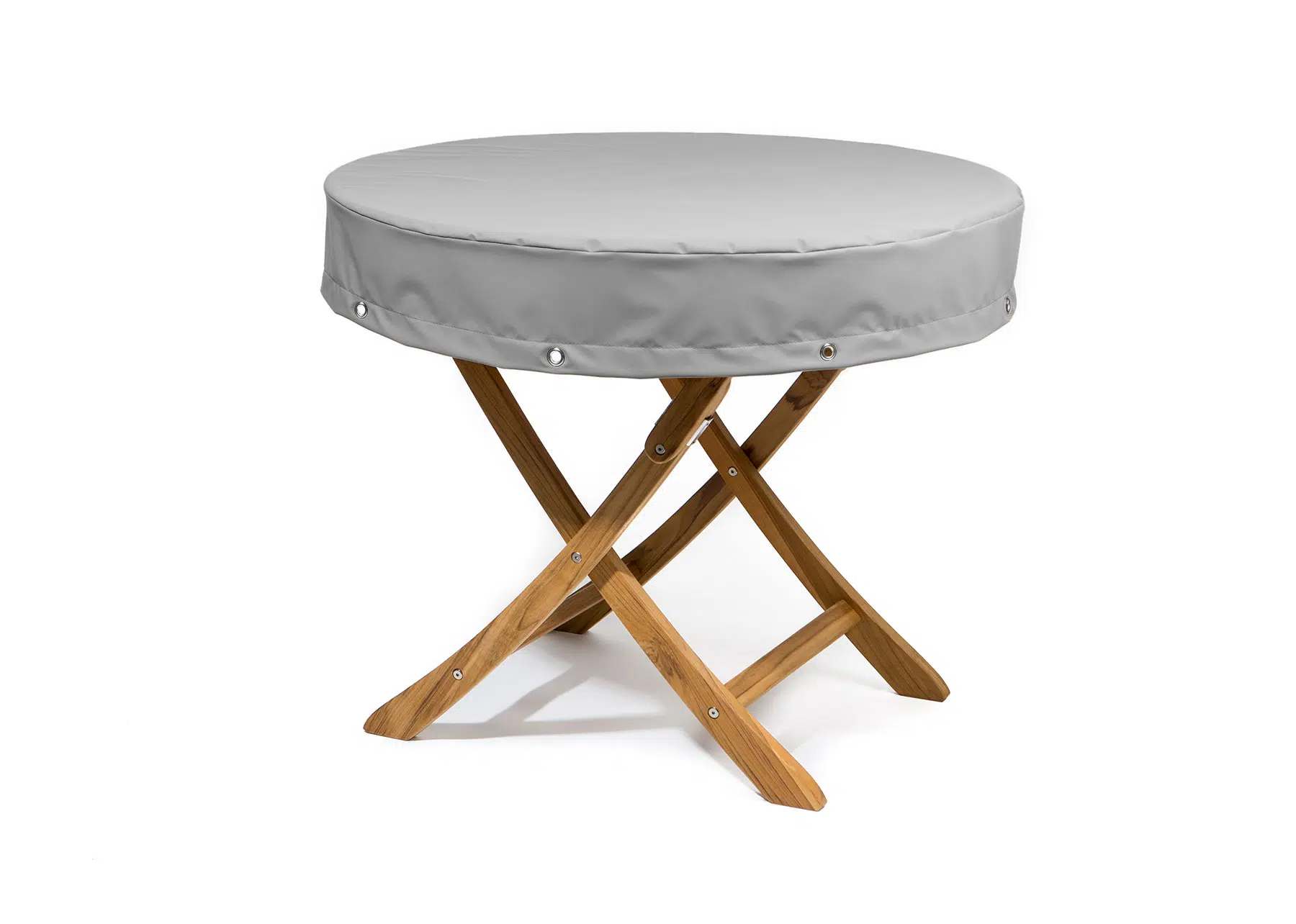 Das Bild zeigt eine runde Abdeckhaube in grauer Farbe, die auf einem holzfarbenen Hocker steht. Die Haube ist mit Rundösen versehen und steht vor einem weißen Hintergrund.